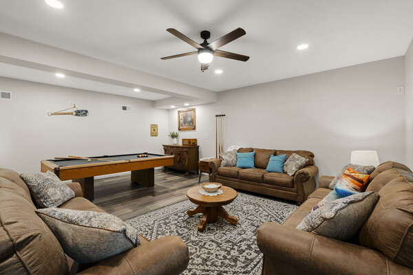 Game room with a pool table and pull out couch